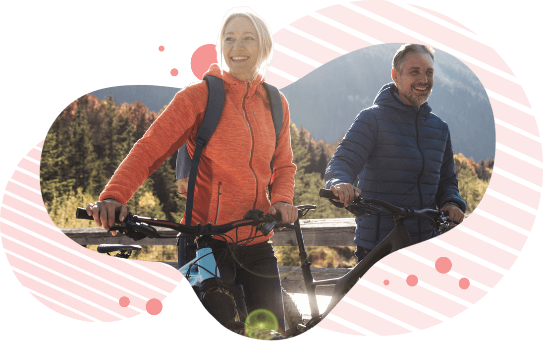 Smiling couple walking beside their bicycles
