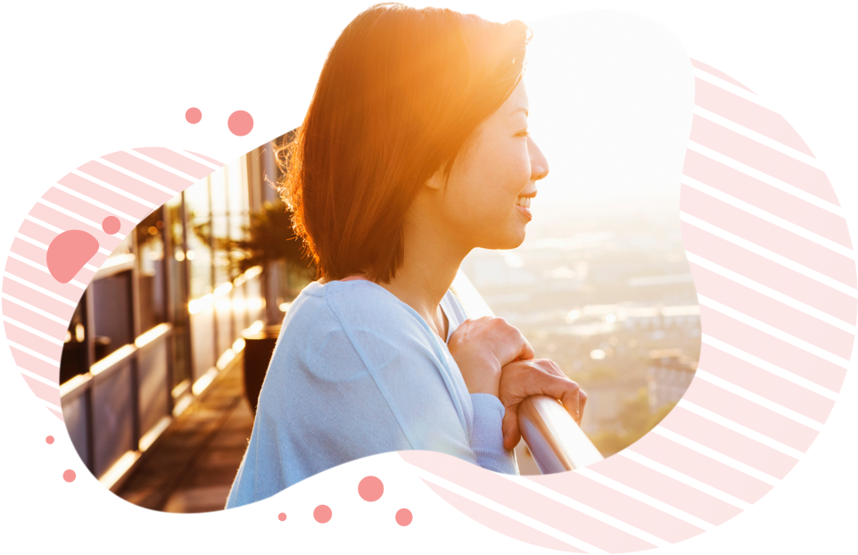 Woman looking out over railing and smiling